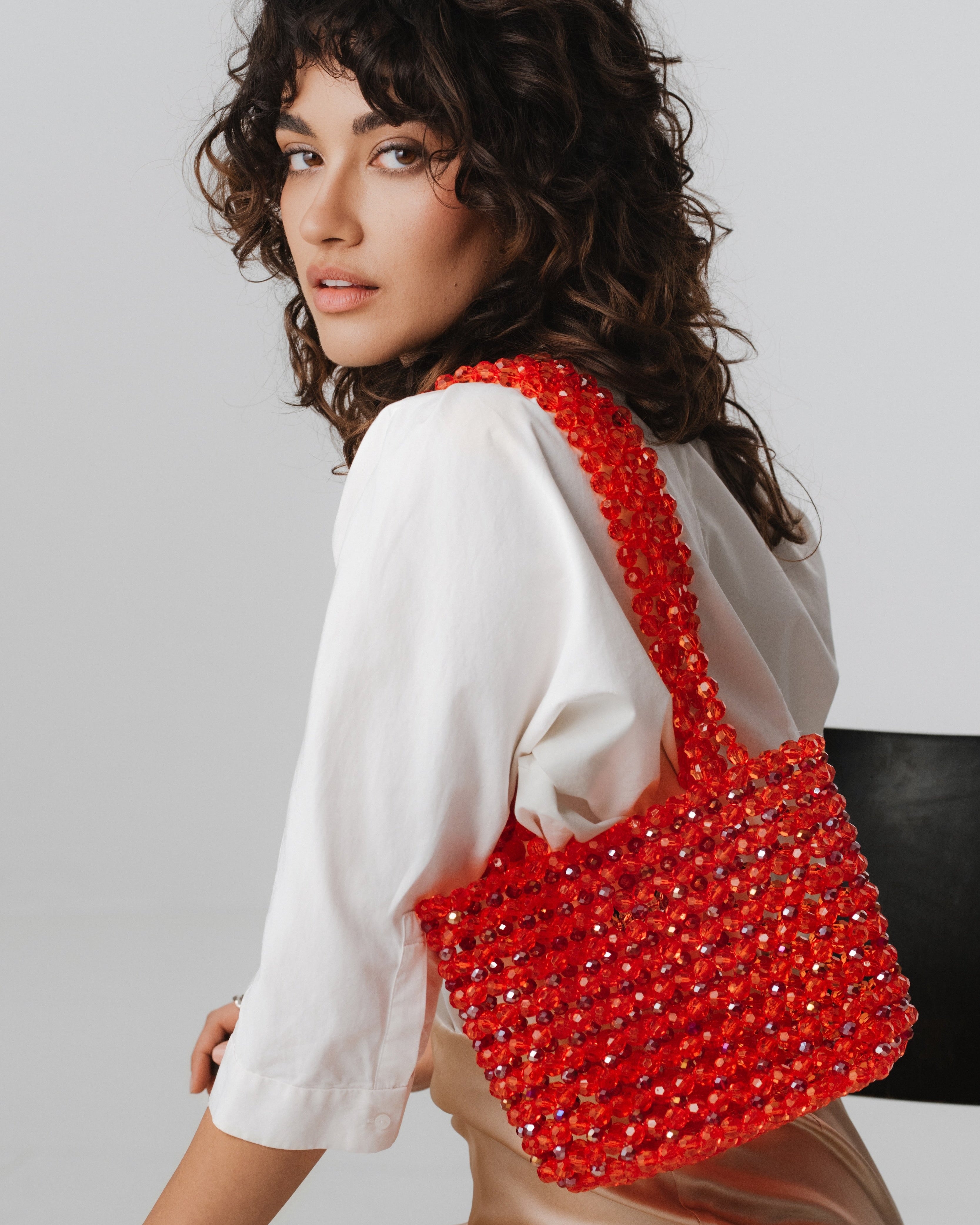Azura glass beaded shoulder bag in red by MAREN LILIAN