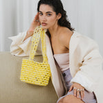 Azura glass beaded shoulder bag  with model in yellow by MAREN LILIAN