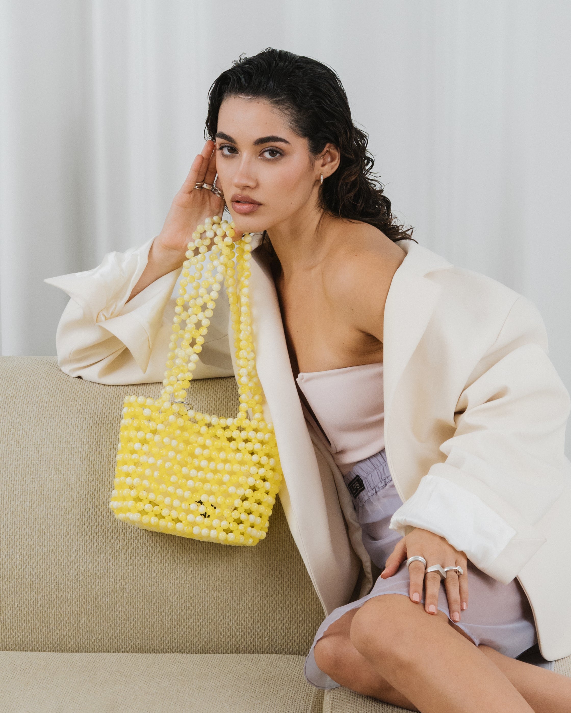 Azura glass beaded shoulder bag  with model in yellow by MAREN LILIAN