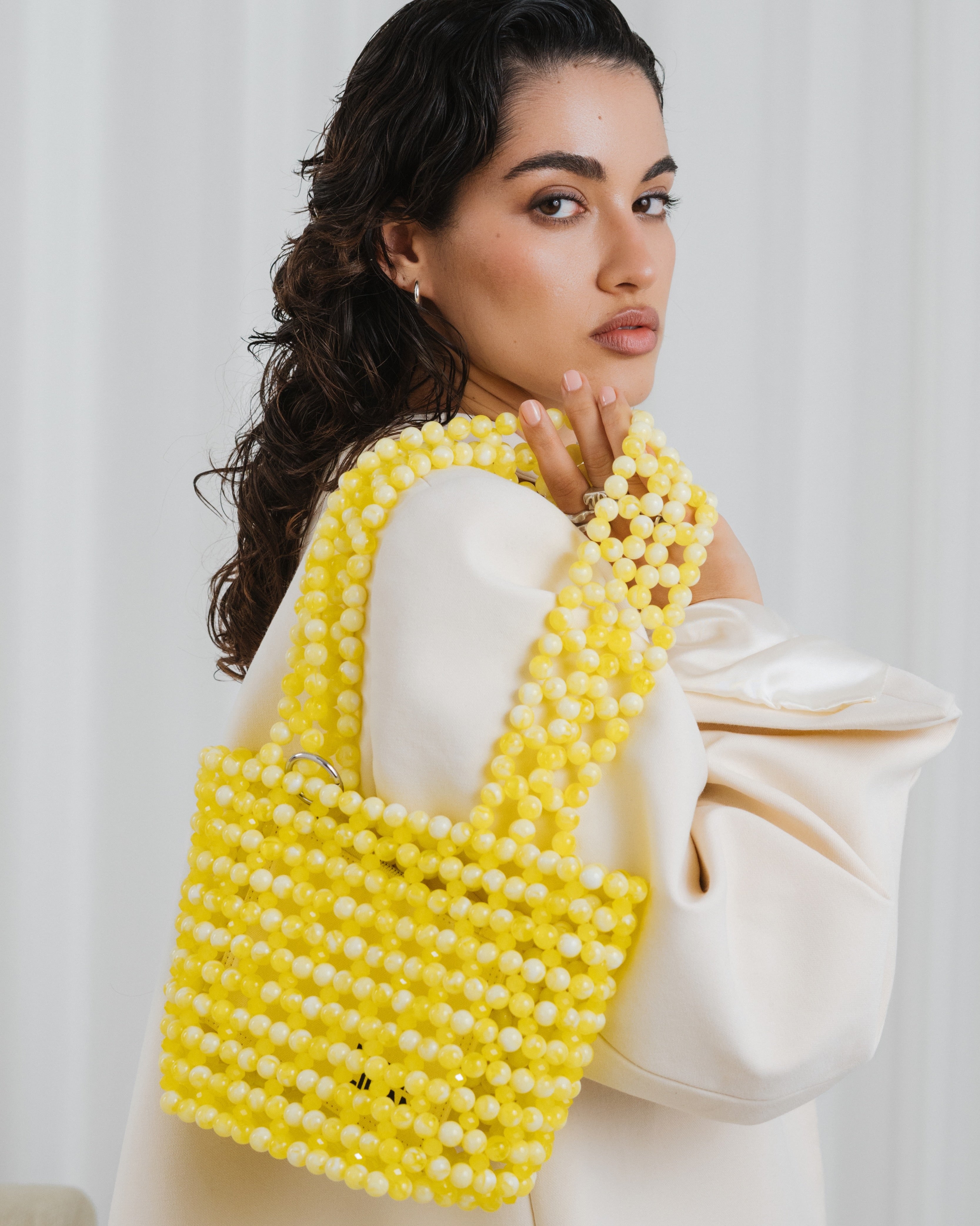 Azura glass beaded shoulder bag with model in yellow by MAREN LILIAN
